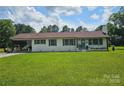 Charming one-story home with a white brick exterior and well-manicured front lawn at 3546 Kershaw Camden Hwy, Lancaster, SC 29720