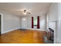 Hardwood floors and fireplace accent the bright living area, complemented by natural lighting and neutral paint at 357 N Main St, Mount Pleasant, NC 28124