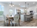 Eat-in kitchen featuring white cabinets, stainless steel appliances, and a stylish island at 4038 Jenison Valley Ct, Charlotte, NC 28214