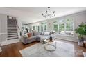 Spacious living room filled with natural light, showcasing the hardwood floors, large windows, and elegant decor at 5005 Chestnut Knoll Ln, Charlotte, NC 28269