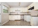 Bright kitchen featuring white cabinetry, modern countertops, and a stainless steel sink at 5143 Delivau Dr, Charlotte, NC 28215