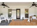 Cozy front porch with rocking chairs, ceiling fans, and a welcoming entrance at 515 N Main Gq St, Granite Quarry, NC 28146