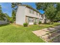 Charming townhouse with a well-manicured lawn and mature trees on a sunny day at 5226 Fair Wind Ln, Charlotte, NC 28212