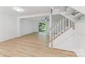 Open-concept living area with wood-look flooring and staircase at 5226 Fair Wind Ln, Charlotte, NC 28212