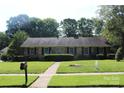 Classic brick home with manicured lawn, showcasing a welcoming exterior and well-maintained landscaping at 7017 Knightswood Dr, Charlotte, NC 28226
