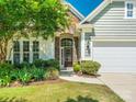 Close up view of the front entrance with stone accents and well landscaped garden beds enhancing the curb appeal at 8036 Crater Lake Dr, Fort Mill, SC 29707
