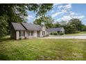 View of two well-maintained homes with green lawns and mature trees; a peaceful, inviting community at 903 Brookdale St, Kannapolis, NC 28083