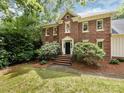Beautiful brick home with lush landscaping around the front yard at 9415 Braemar Ter, Charlotte, NC 28210