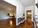 Inviting foyer showcasing hardwood floors and access to other rooms at 9415 Braemar Ter, Charlotte, NC 28210