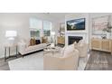 Bright living room featuring a fireplace, contemporary furnishings, and large windows, ideal for relaxation at 1043 20Th Avenue Se Loop, Hickory, NC 28602