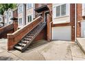 Brick townhome exterior with attached garages and stairs leading to the front door at 1125 Kurt Ct, Charlotte, NC 28209