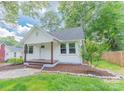 Charming home with a covered front porch and landscaped front yard, creating an inviting curb appeal at 1208 Martin Luther King Ave, Kannapolis, NC 28083