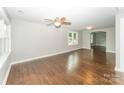 Bright living room featuring beautiful hardwood floors, modern lighting, and a neutral color palette at 1208 Martin Luther King Ave, Kannapolis, NC 28083
