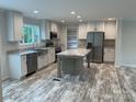 Bright, modern kitchen with stainless steel appliances, island, and stylish countertops at 130 Zircon Dr, Statesville, NC 28625