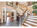 Elegant foyer with hardwood stairs, slate floors, and classic architectural details at 1933 Tara Trl, Lancaster, SC 29720
