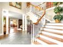 Grand foyer features an elegant staircase with hardwood and tiled floors at 1933 Tara Trl, Lancaster, SC 29720