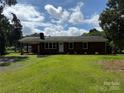 Lovely brick home featuring a classic design, a welcoming porch, and a sprawling green lawn at 208 Winter St, Richfield, NC 28137