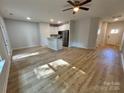 Spacious open-concept living room and kitchen with light hardwood flooring and stainless steel appliances at 219 Pine St, Rockwell, NC 28138