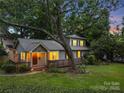 Inviting two-story home with a covered front porch, bathed in the warm glow of evening lighting at 2800 Georgia Ave, Charlotte, NC 28205