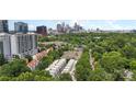 Wide aerial shot showcasing a neighborhood of townhouses and apartments with a backdrop of the city skyline at 297 Mcdonald Ave, Charlotte, NC 28203