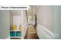 Inviting entryway with hardwood floors, a built-in bench, and stylish decor creates a warm first impression at 3122 Spring Iris Dr, Denver, NC 28037