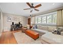 Inviting living room featuring hardwood floors, a large bay window, and a cozy seating area at 3612 Trent St, Charlotte, NC 28209