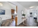 Bright hallway with hardwood flooring leading to an open-concept kitchen and a cozy living room at 3908 Parkers Ferry Rd, Fort Mill, SC 29715