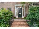 Elegant brick home entrance with a black door and decorative accents at 4007 Lake Shore S Rd, Denver, NC 28037