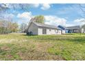 Large backyard featuring sliding glass doors, a well-manicured lawn, and plenty of natural light at 425 Austin Dr, Charlotte, NC 28213