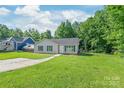 Well-kept one-story home featuring a lush green lawn and a cozy, inviting facade at 425 Austin Dr, Charlotte, NC 28213
