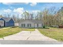 Charming single-story home featuring blue shutters, a concrete driveway, and a well-maintained front lawn at 425 Austin Dr, Charlotte, NC 28213