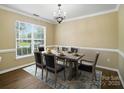 Formal dining room featuring wood floors, ample natural light, and chandelier at 4982 Bentgrass Run Dr, Charlotte, NC 28269
