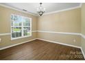 Formal dining room featuring wood floors, ample natural light, and chandelier at 4982 Bentgrass Run Dr, Charlotte, NC 28269