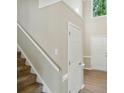 Bright entryway features wood floors, a staircase, and an open floor plan at 4982 Bentgrass Run Dr, Charlotte, NC 28269