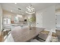 Dining area featuring a table set with seating, and a pendant light fixture above at 513 Sacco St, Belmont, NC 28012