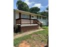 Inviting front porch with wooden railings and a walkway leading to the entrance at 5200 Queen Anne Rd, Charlotte, NC 28217