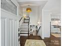 Bright foyer showcasing hardwood floors and an elegant staircase at 5436 Topping Pl, Charlotte, NC 28209