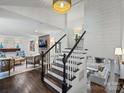 Staircase leading to the living room and a cozy seating area with a brick fireplace at 5436 Topping Pl, Charlotte, NC 28209