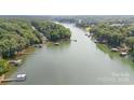 Breathtaking aerial view showcasing the lake and lush landscape, offering a serene and private waterfront lifestyle at 6836 Summer Hill Dr, Denver, NC 28037