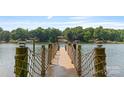 Scenic view from the wooden dock, featuring rope accents and clear water, perfect for enjoying lake living at 6836 Summer Hill Dr, Denver, NC 28037