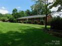 Classic brick ranch-style home with a lush green lawn, mature trees, and manicured shrubbery enhancing curb appeal at 714 Shady Dr, Albemarle, NC 28001