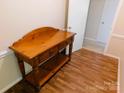 Entryway featuring a classic wooden console table with drawers and a lower shelf, leading to additional rooms at 714 Shady Dr, Albemarle, NC 28001