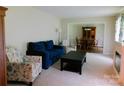Bright living room with comfortable seating, a view into the dining area, and ample natural light at 714 Shady Dr, Albemarle, NC 28001