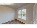 Cozy office features natural light, wood floors, crown molding, and a glass door for a quiet workspace at 7172 Sylvan Retreat Dr, Denver, NC 28037