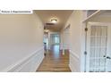 Bright foyer featuring hardwood floors, paneled walls, recessed lighting and a glass paneled door at 7190 Sylvan Retreat Dr, Denver, NC 28037