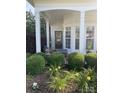 Inviting covered front porch with comfortable seating and beautiful landscaping at 919 Lily Magnolia Ct, Fort Mill, SC 29707