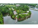 Breathtaking aerial view of waterfront condos featuring boat docks, swimming pool, and serene surroundings at 921 Northeast Dr, Davidson, NC 28036