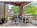 Charming balcony with outdoor seating, wood floors and brick accents, perfect for relaxation at 921 Northeast Dr, Davidson, NC 28036