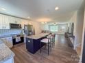 Open-concept kitchen with stainless steel appliances, granite countertops and an island with seating at 103 Springway Dr, Kannapolis, NC 28081