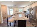 Bright kitchen featuring granite countertops, stainless steel appliances and a view to backyard at 103 Springway Dr, Kannapolis, NC 28081